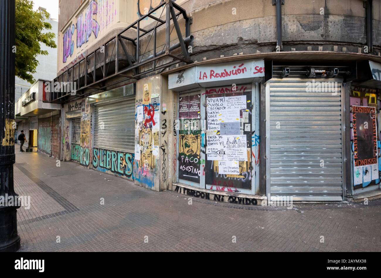 Graffiti and posters from the political unrest and protests on shuttered shops in Lastarria, Central Santiago, Metropolitan Region, capital of Chile Stock Photo