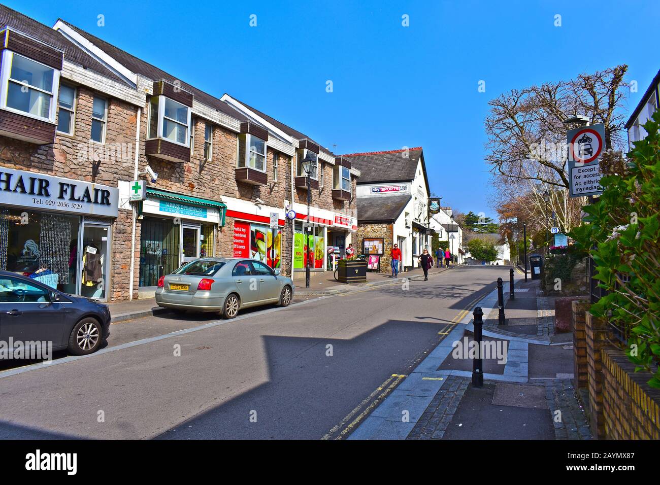 A general street view of the High Street in the Village of Llandaff, with a mix of small retail shops, cafés & restaurants. Shoppers cars parked. Stock Photo