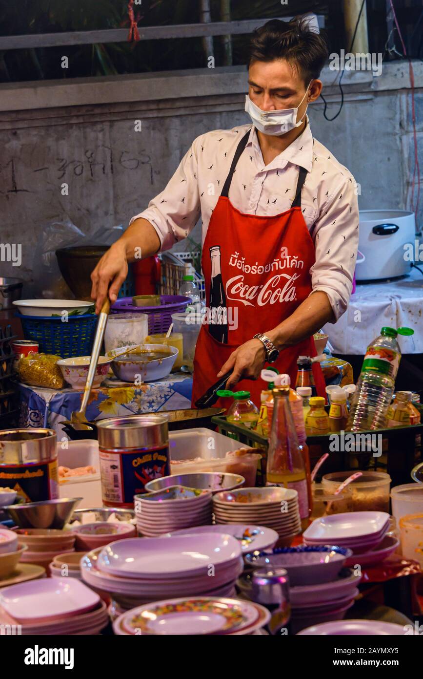 A Street Food Chef Wears A Face Mask To Protect Him Against Coronavirus Covid 19 As He Cooks Meals In A Street Restaurant On The Streets Of Bangkok Thailand Stock Photo Alamy