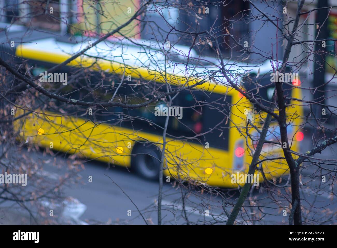 View of a blurred yellow public transport bus in the streets of Berlin, Germany in winter. Stock Photo