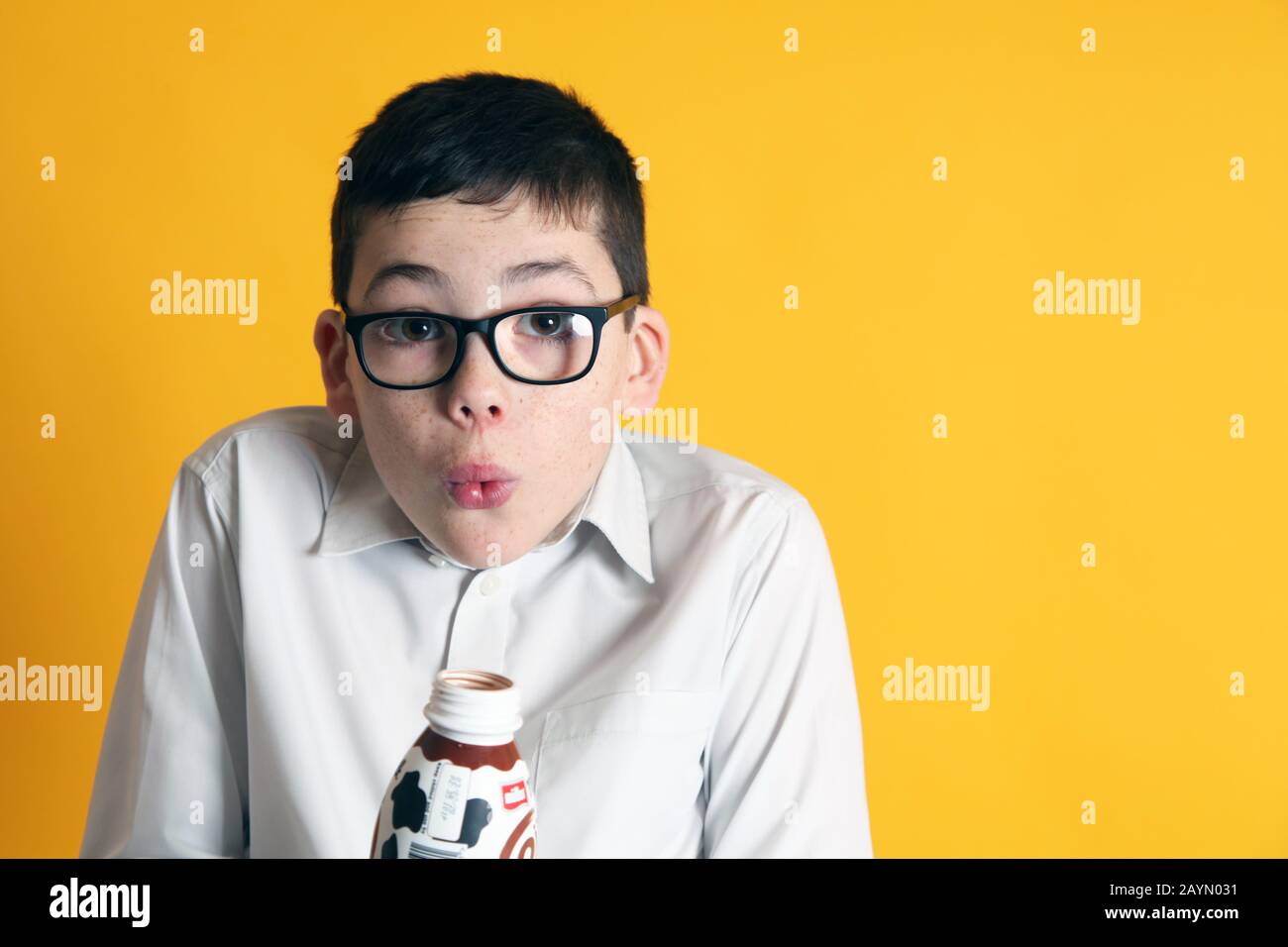 A young boy aged 8yrs old drinks a bottle of Muller Frijj chocolate