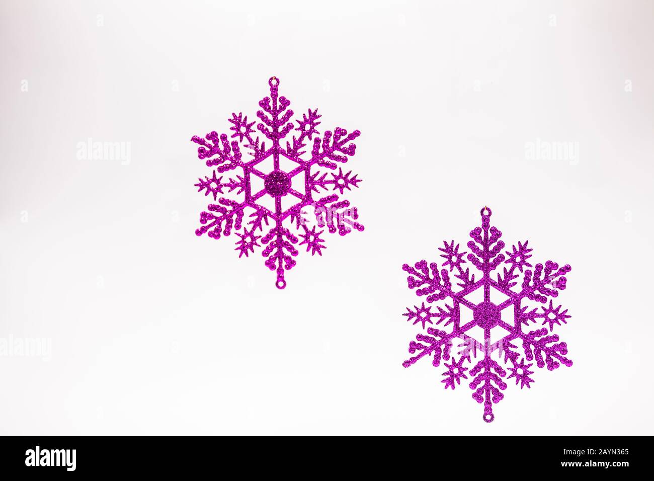 2 purple Christmas snowflakes on a white background Stock Photo