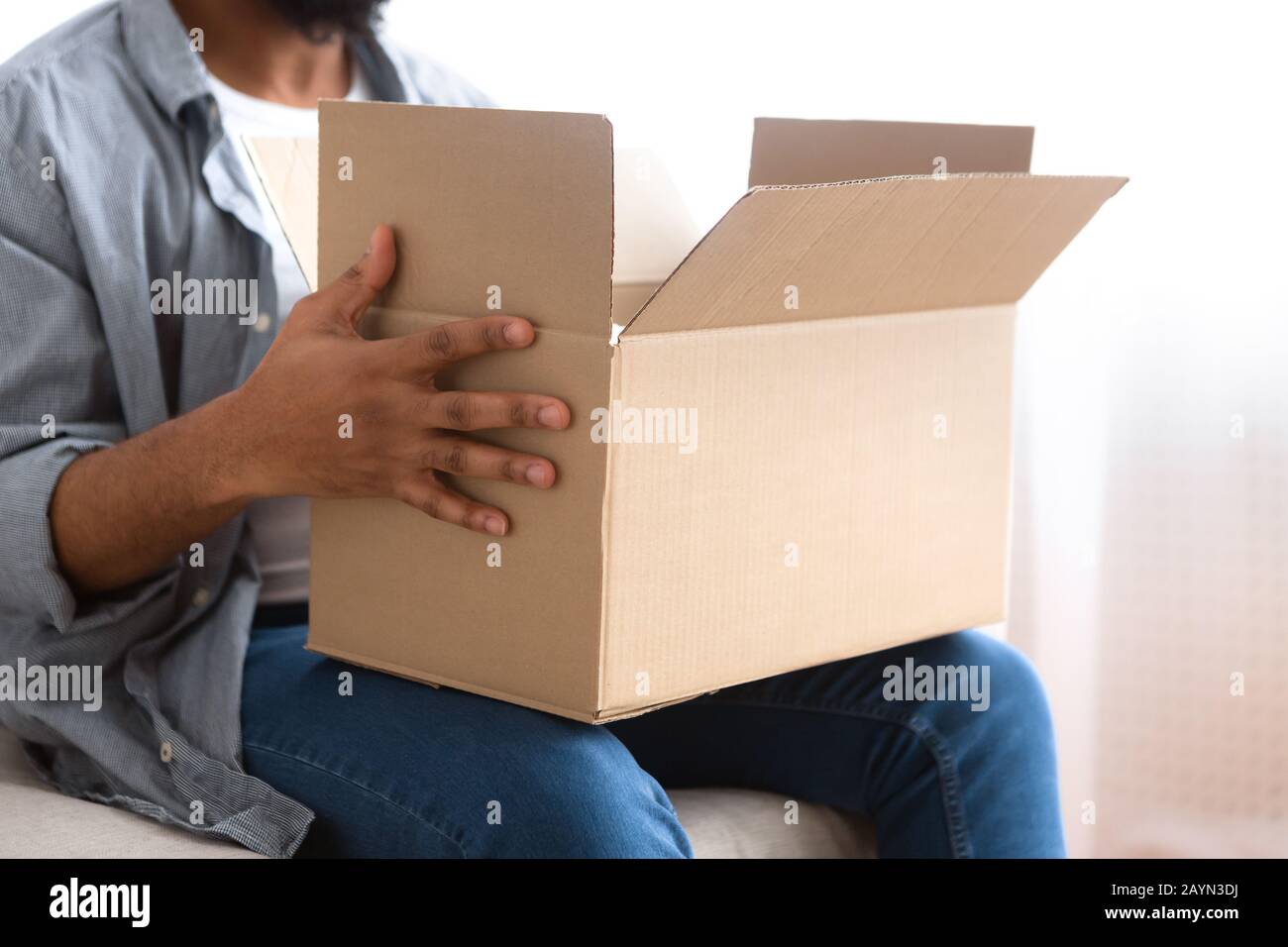 Afro american man holding big box with online purchases Stock Photo