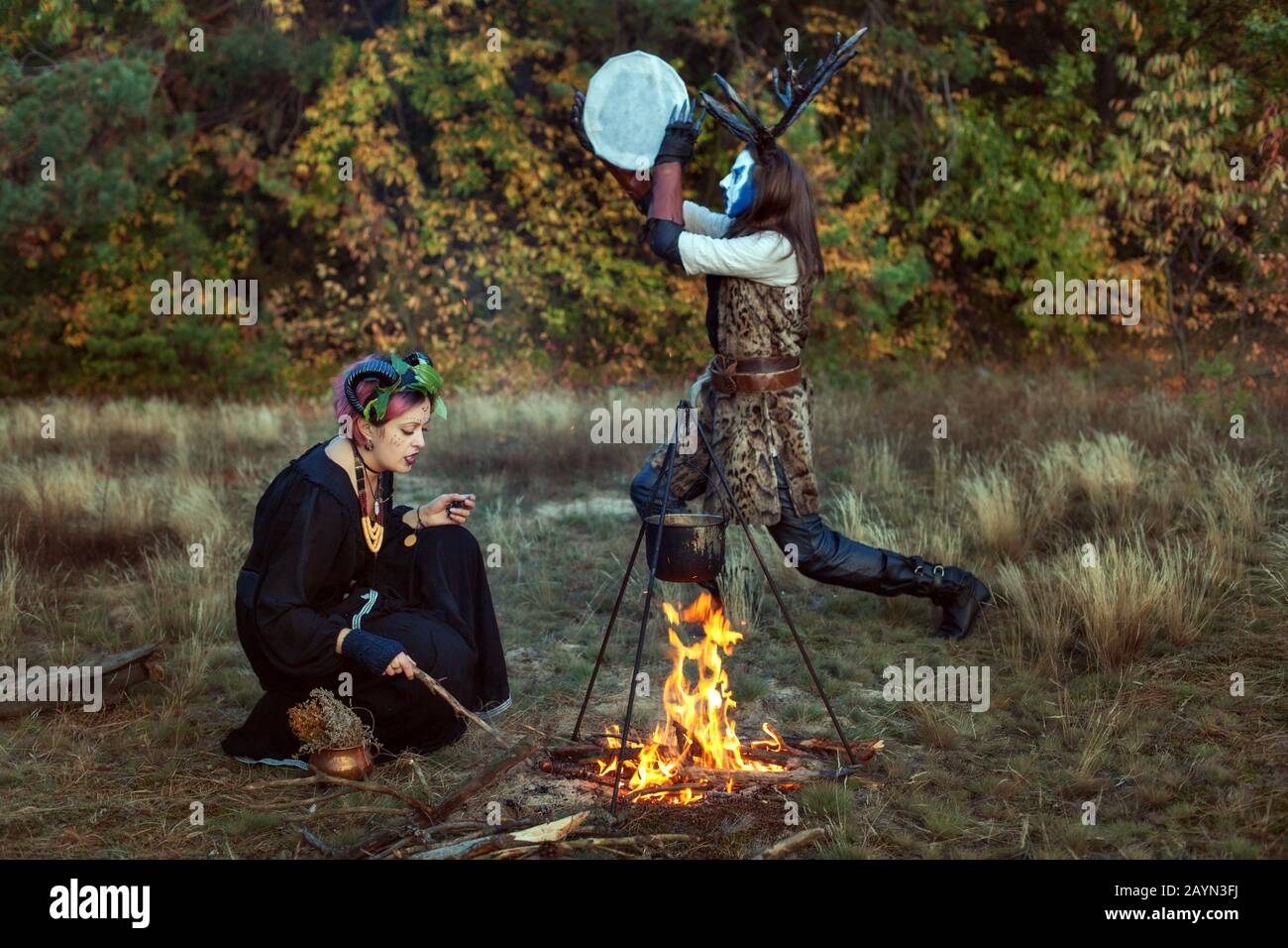 Shamans conduct ritual rites in the forest. They make a magic potion. Stock Photo