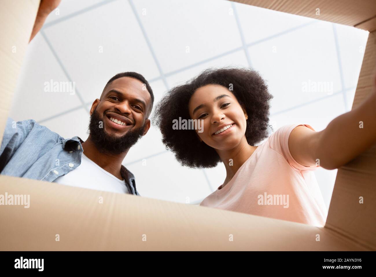 African American couple opening parcel at home Stock Photo