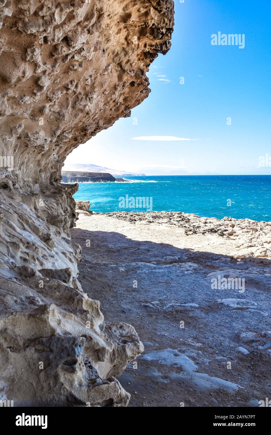 Volcanic rock curved and framing landscape of Atlantic Ocean, cliffs ...