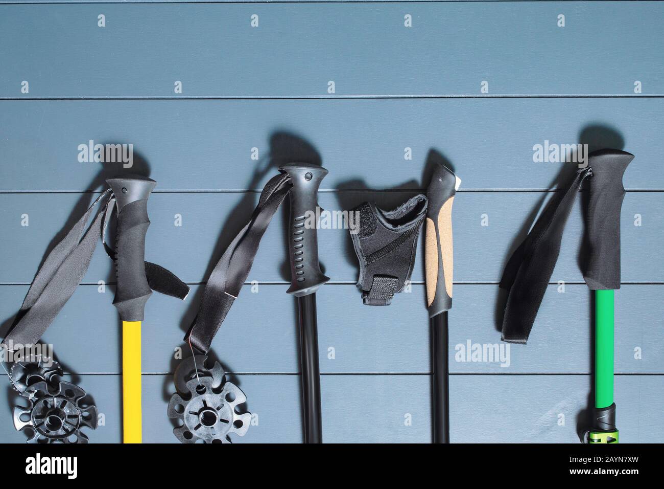 Flat lay top view of set of many hiking or ski poles on a wooden background Stock Photo