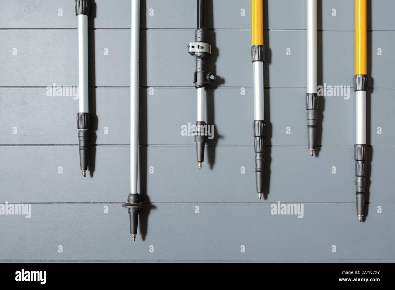 Flat lay top view of set of many hiking or ski poles on a wooden background Stock Photo