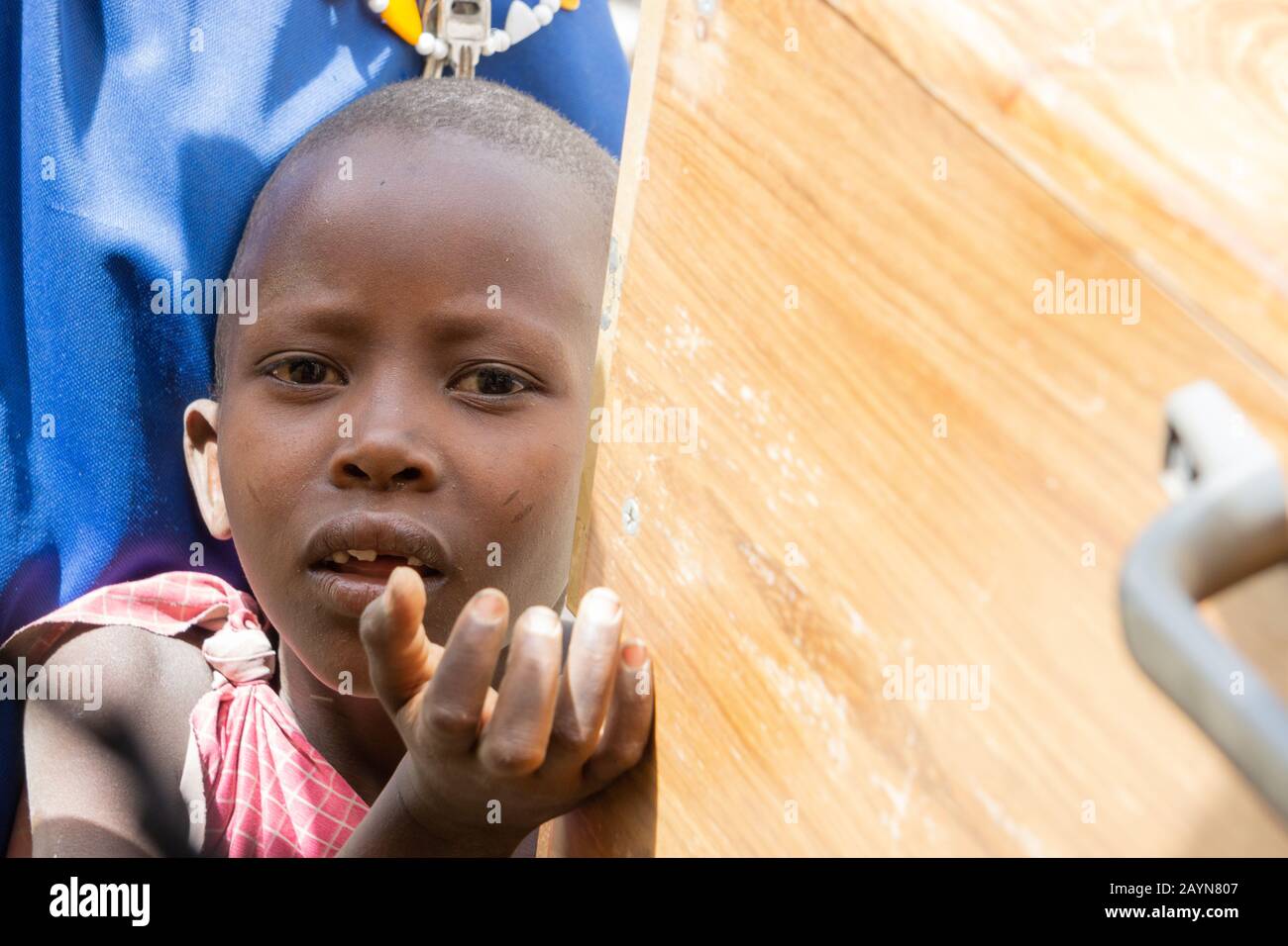NGARE SERO. TANZANIA - AUGUST 20, 2019: child asks for something to eat at Ngare Sero area near Lake Natron and Ol Doinyo Lengai volcano in Tanzania Stock Photo