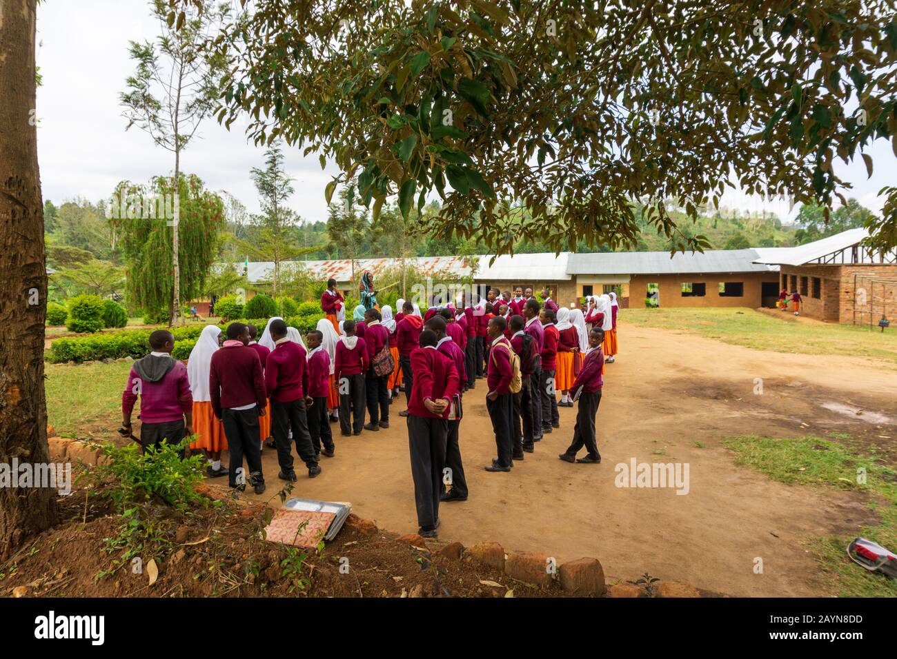 LUSHOTO, TANGA REGION, TANZANIA - AUGUST 22, 2019: in the forecourt of a high school students are listening to the speech of director of the school Stock Photo