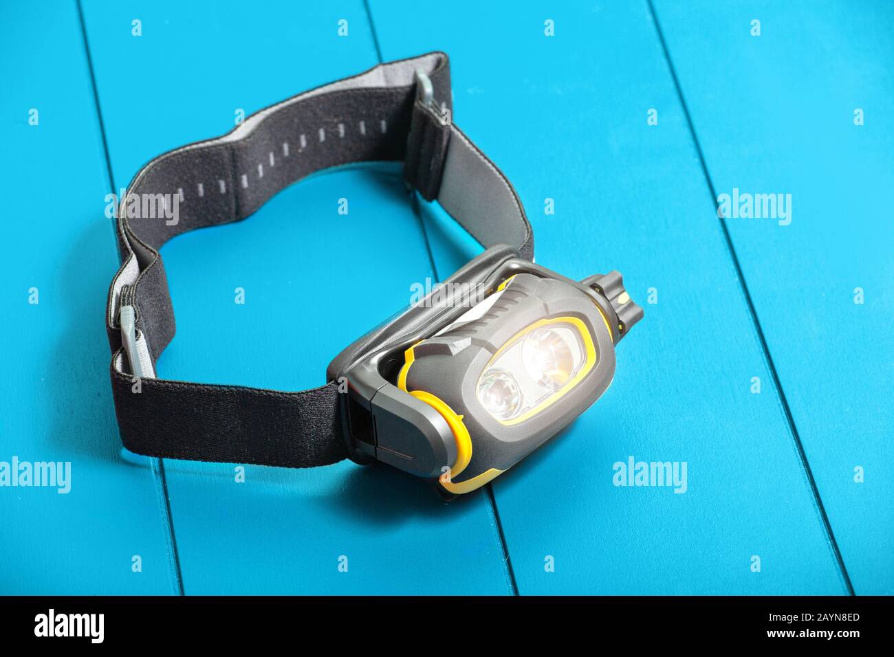 Camping Headlamp on blue table background Stock Photo