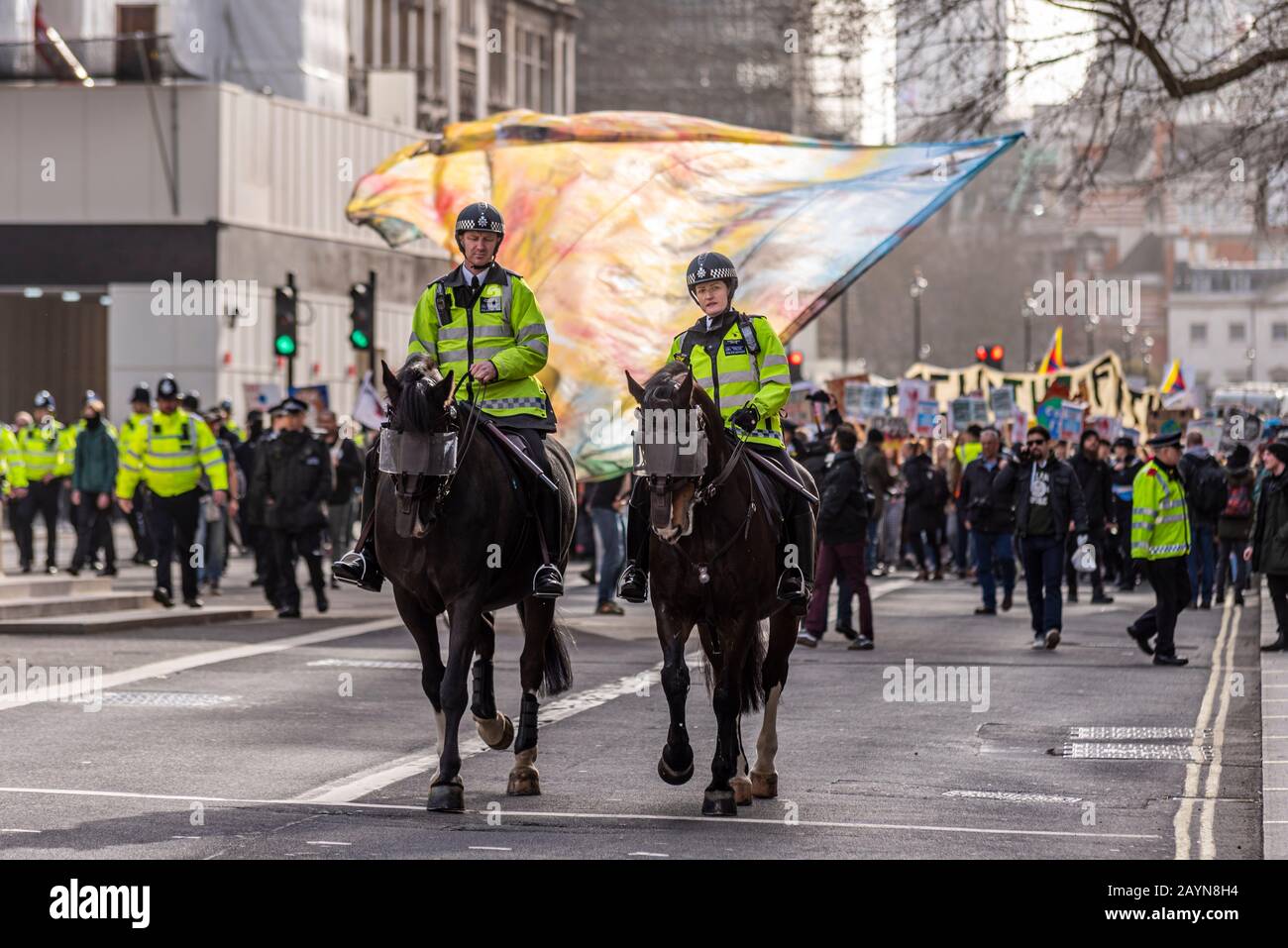 Metropolitan Police escorting Youth Strike 4 Climate protest demonstration march in Whitehall, Westminster, London, UK. Mounted police Stock Photo