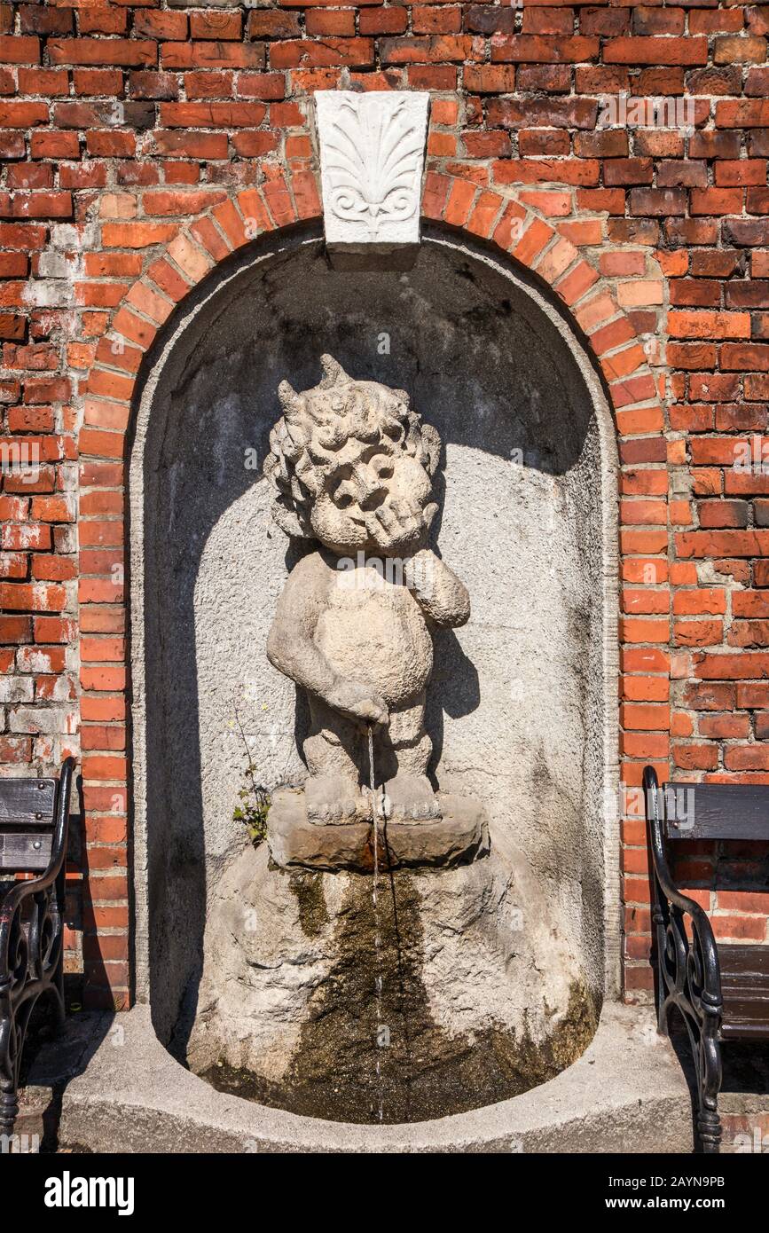Grotesque figure at waterspout fountain at wall of Sulkowski Castle in Bielsko-Biala, Silesia, Poland Stock Photo