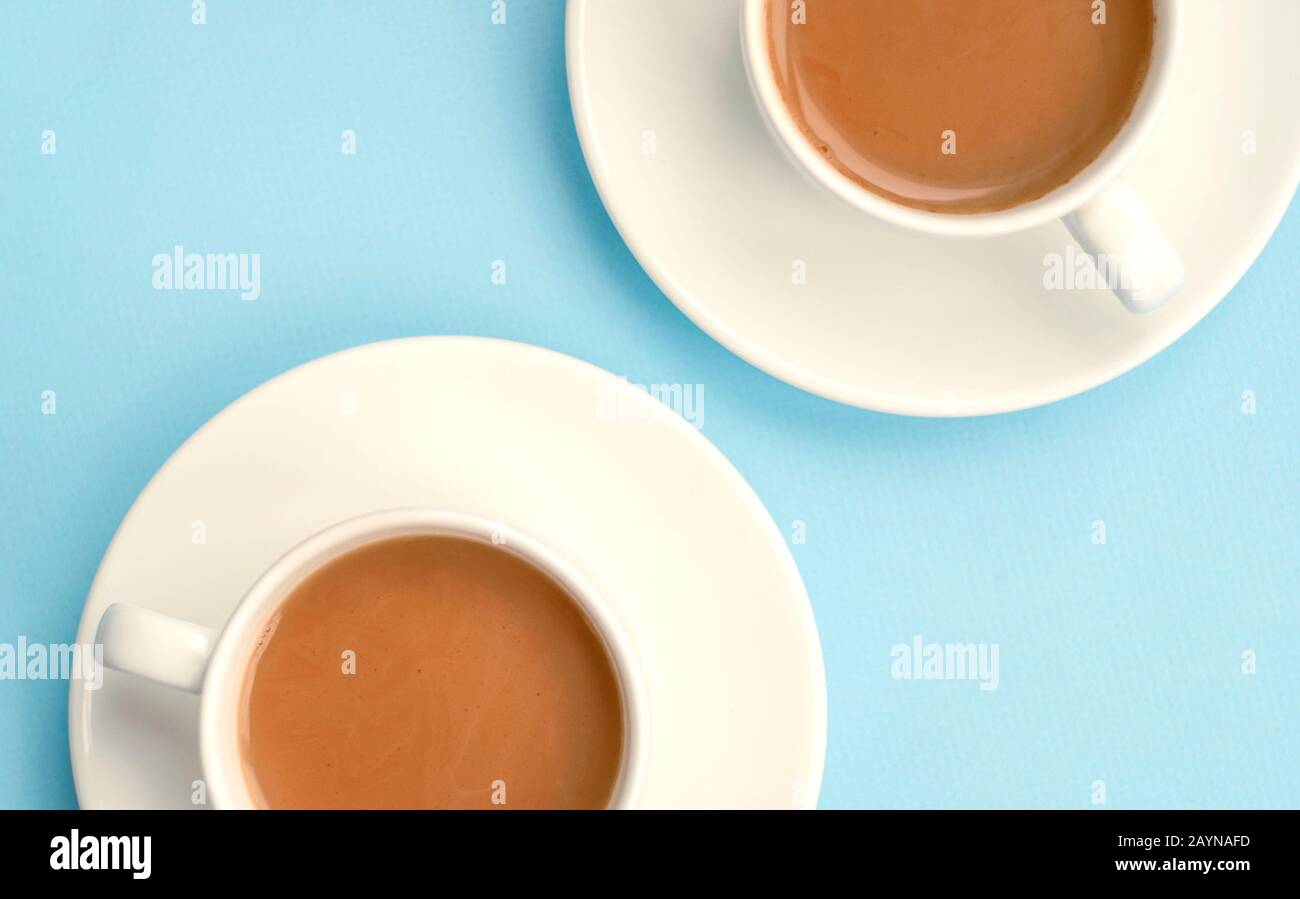 Two white cups coffee with milk, light blue background, top view. Americano. Copy space Stock Photo