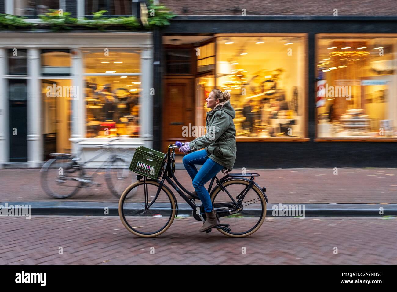 A cyclist riding past with a blurred background on a street in ...