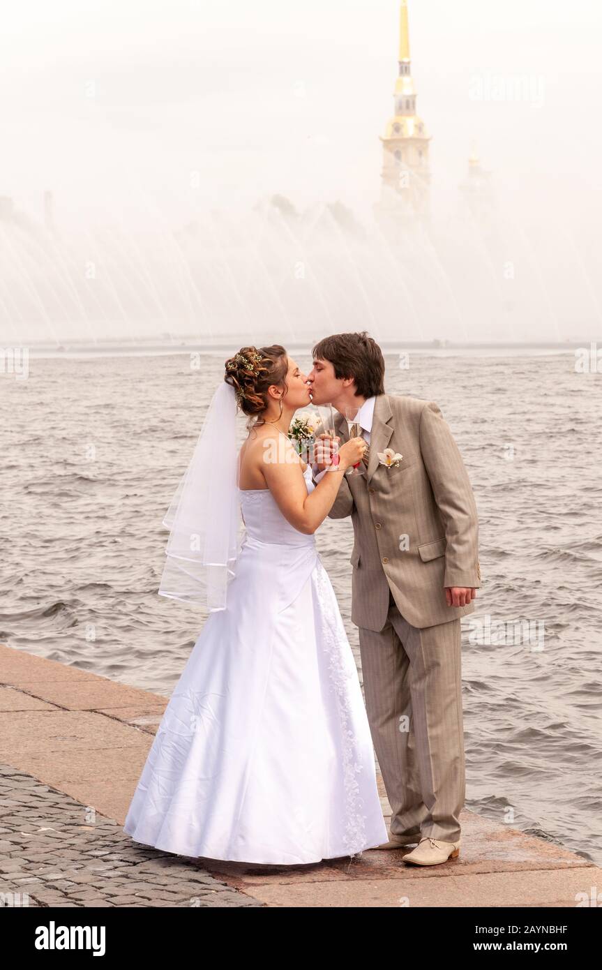 Newlyweds kissing on the embankment of the river Neva, St Petersburg, Russia Stock Photo