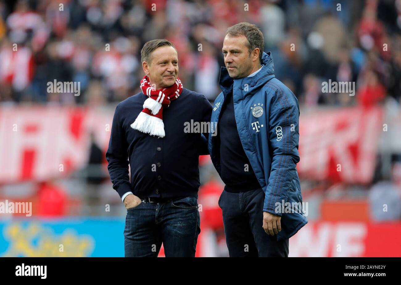 Koeln, Germany, RheinEnergieStadion, 16th Feb 2020: Manager Horst Heldt of Koeln talks with Head coach Hans-Dieter Flick of Muenchen prior the first Bundesliga match 1.FC Koeln vs. FC Bayern Muenchen in the season 2019/2020.  DFL regulations prohibit any use of photographs as image sequences and/or quasi-video. Credit: Mika Volkmann/Alamy Live News Stock Photo