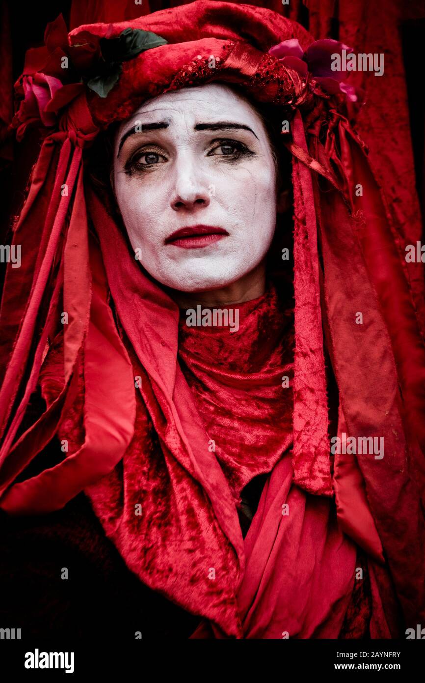 Portrait of member of Invisible Circus Red Brigade environmental activist group at Extinction Rebellion demonstration. London, UK Stock Photo