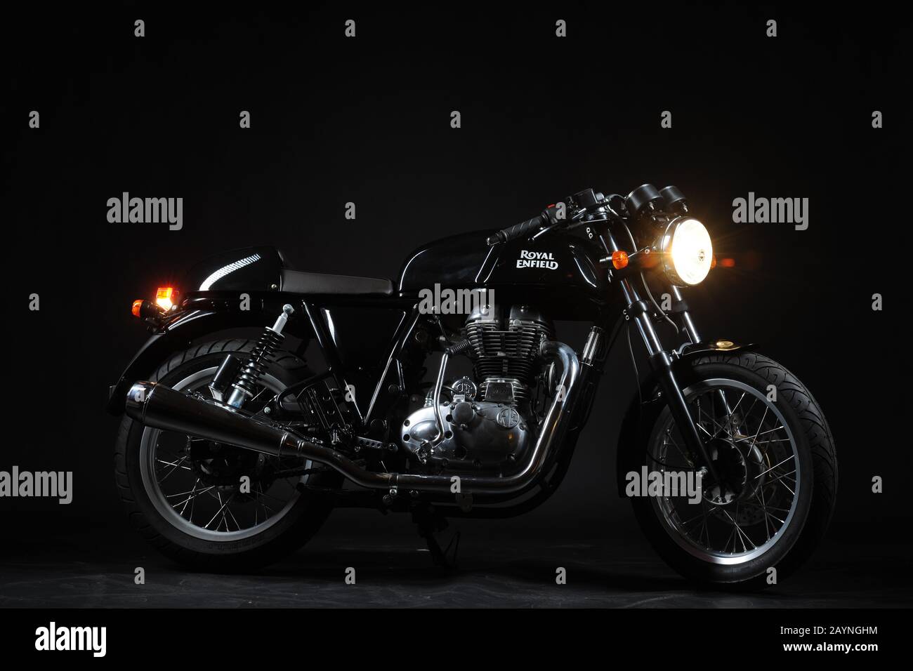 a classic black motorcycle in front of a black studiobackdrop Stock Photo