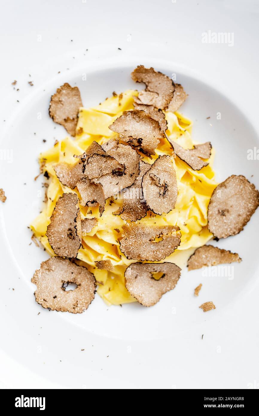 Dish of delicious italian pasta with truffle mushroom chips, on the