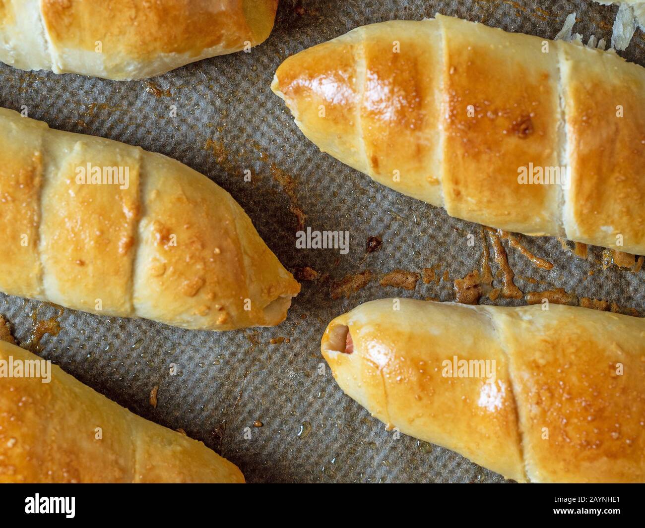 Top view of The finished juicy sausage in the dough. Close-up of flour products Stock Photo
