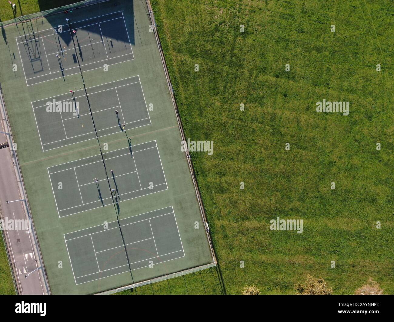 aerial view of parkland showing tennis courts in evening sunshine Stock