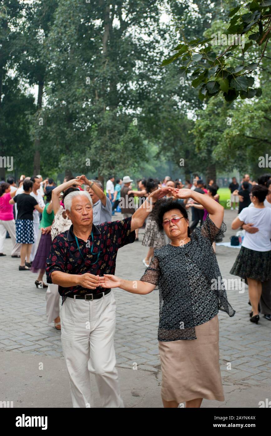 Chinese People Exercising By Dancing In A Park Near The Temple Of Chinese People Exercising By Dancing In A Park Near The Temple Of