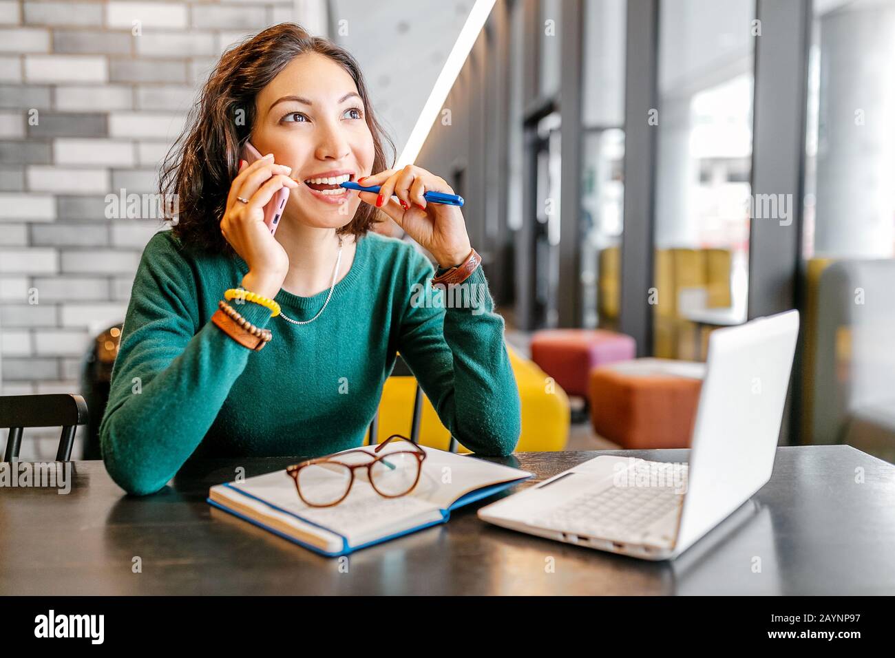 Happy asian woman using notebook computer and smartphone while thinking about new ideas for business or education Stock Photo