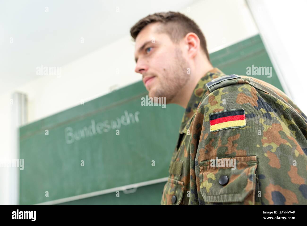 German soldier stands in a classroom . German word Bundeswehr, means ...