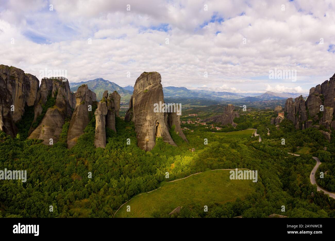 Aerial panorama view of a slide from a drone on a panorama of a mountain range. Kalampaka city, Greece. View of the cliffs of Meteora and the monaster Stock Photo