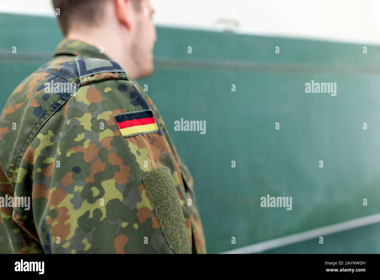 German soldier stands in a classroom . German word Bundeswehr, means ...