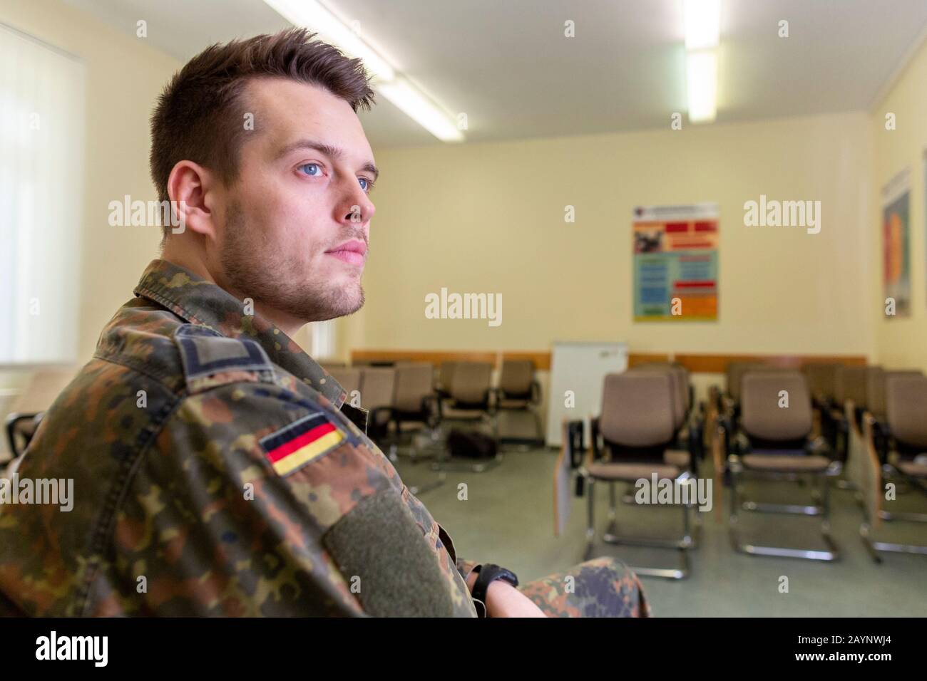 German soldier sits in a classroom . German word Bundeswehr, means