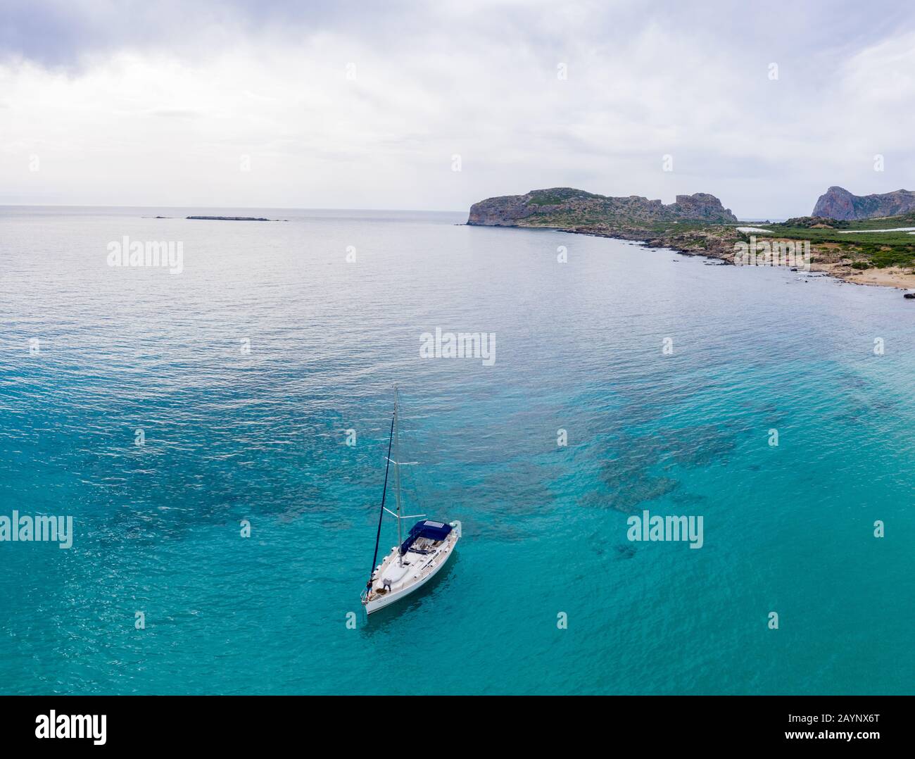 Aerial panoramic drone top view photo of sail boat sailing in mediterranean Aegean island of Crete Greece in summer Stock Photo