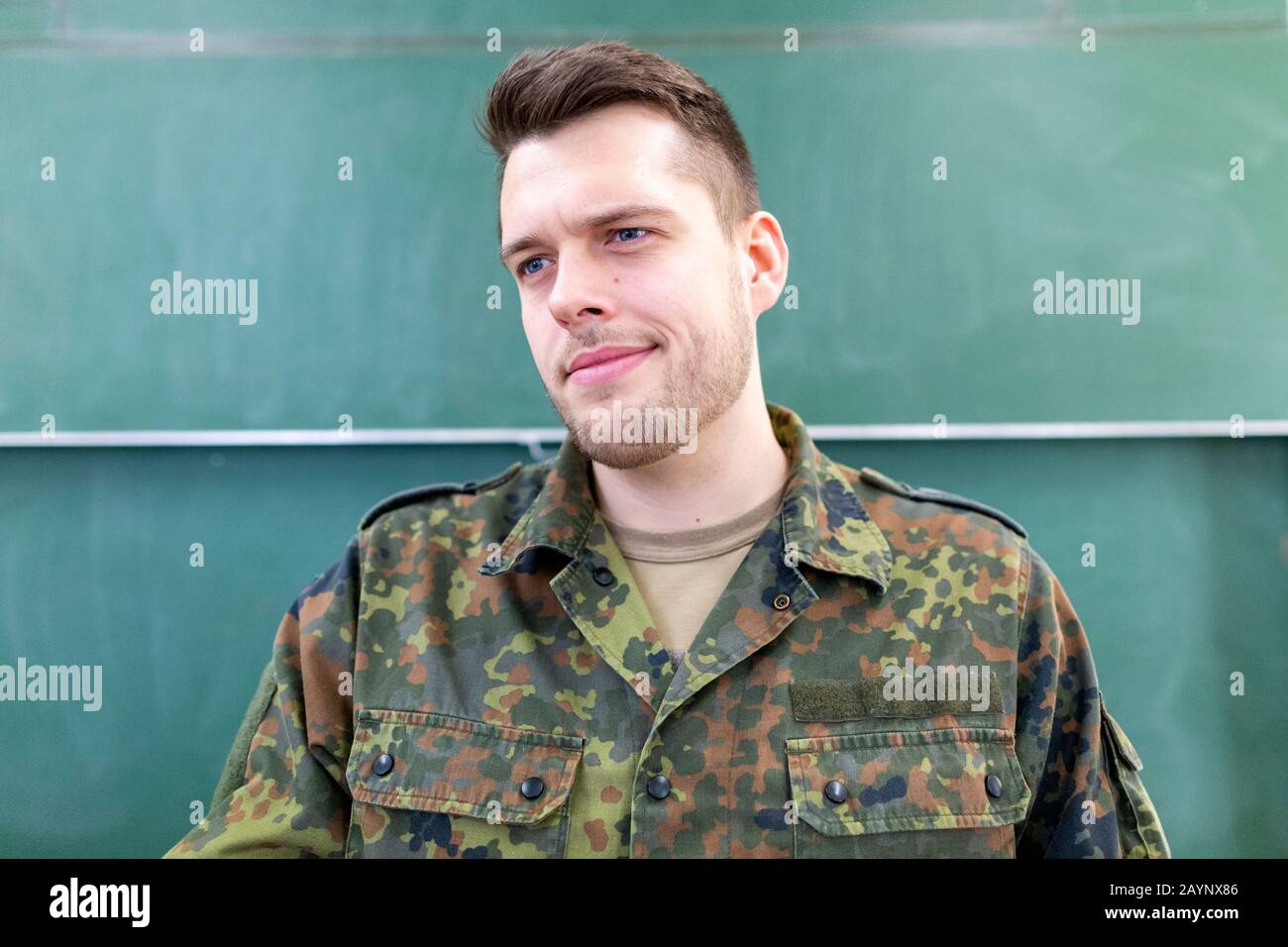 German soldier stands in a classroom . German word Bundeswehr, means