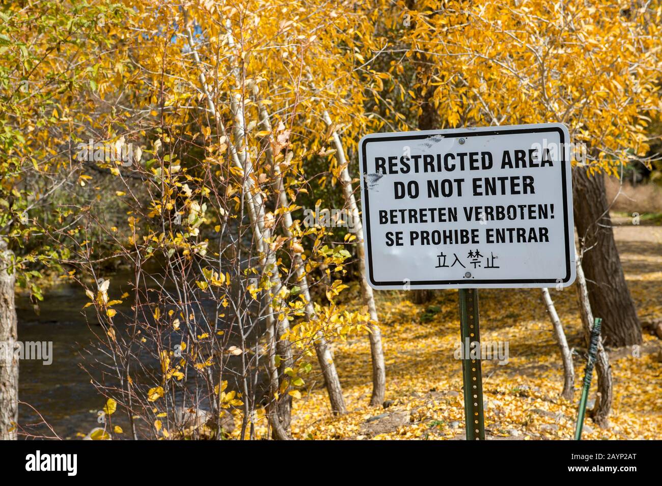 Multi-lingual Restricted Area sign at the Taos Pueblo which is the only living Native American community designated both a World Heritage Site by UNES Stock Photo