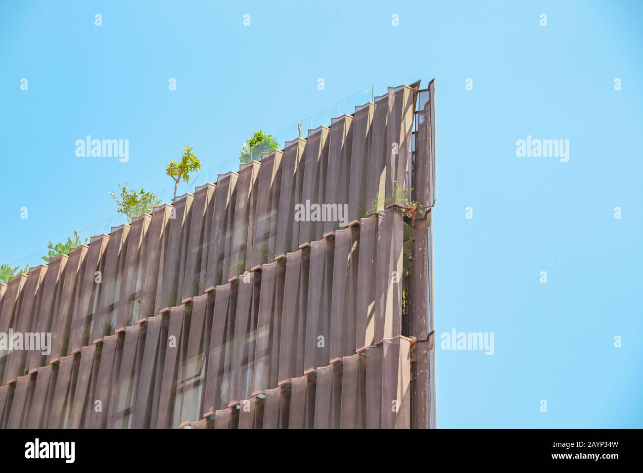 A generic building filled with trees in an effort to promote sustainable lifestyle (Smart city concept) in the city of Bangkok, Thailand Stock Photo