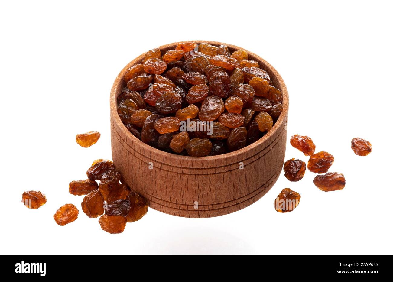 Raisins in wooden bowl isolated on white background Stock Photo
