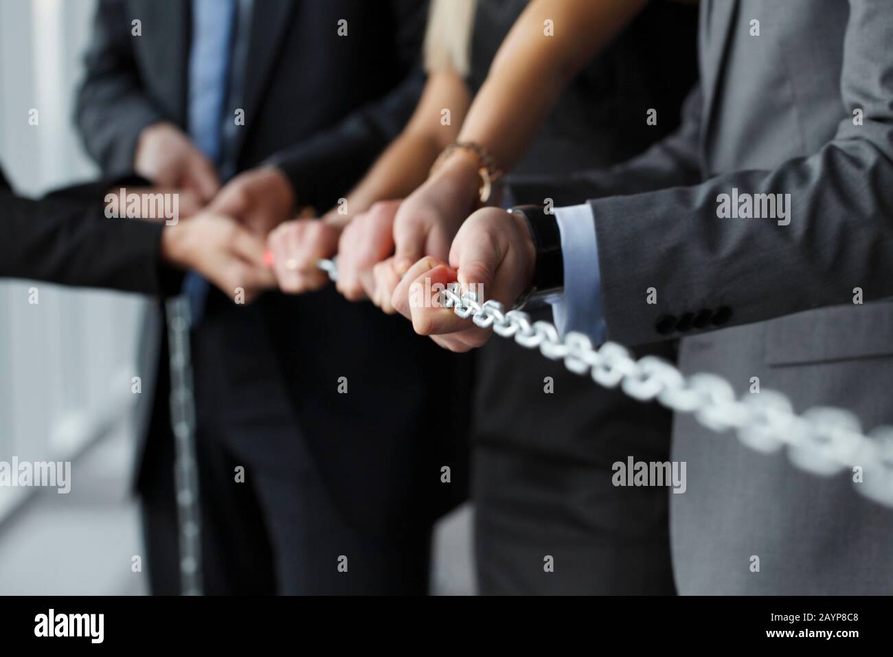 Business team pulling steel chain together cooperation unity concept Stock Photo Alamy