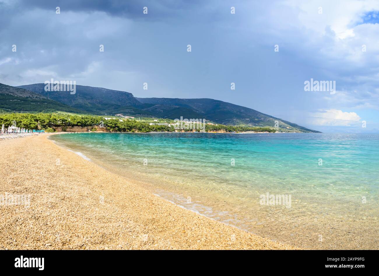 Pebble beach Zlatni Rat or Golden Horn or Golden Cape in Bol town, Brac Island, Croatia. Gravel beach, mountain and turquoise water of Adriatic Sea on Stock Photo