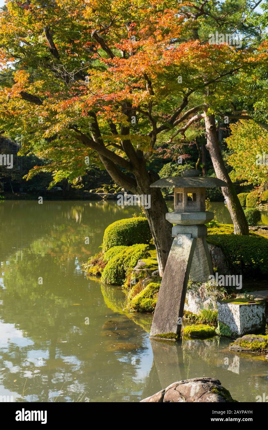 The stone lantern at the pond (designed in the image of the Japanese koto (harp)), is the symbol of Kenrokuen Garden in Kanazawa, Ishikawa Prefecture, Stock Photo