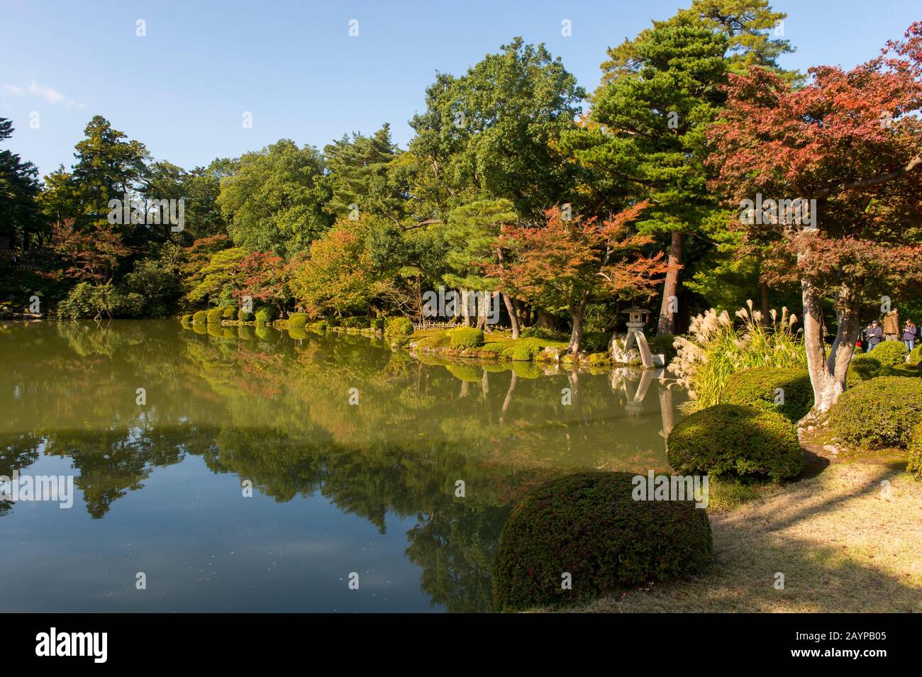 View of the pond with a stone lantern designed in the image of the Japanese koto (harp), which is the symbol of Kenrokuen Garden in Kanazawa, Ishikawa Stock Photo