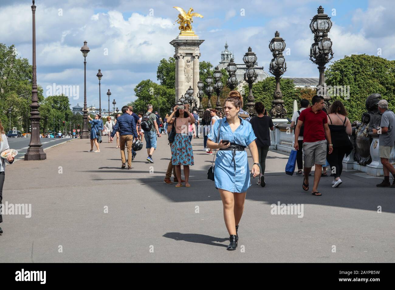Woman walking and texting on phone in Paris, France, Europe Stock Photo