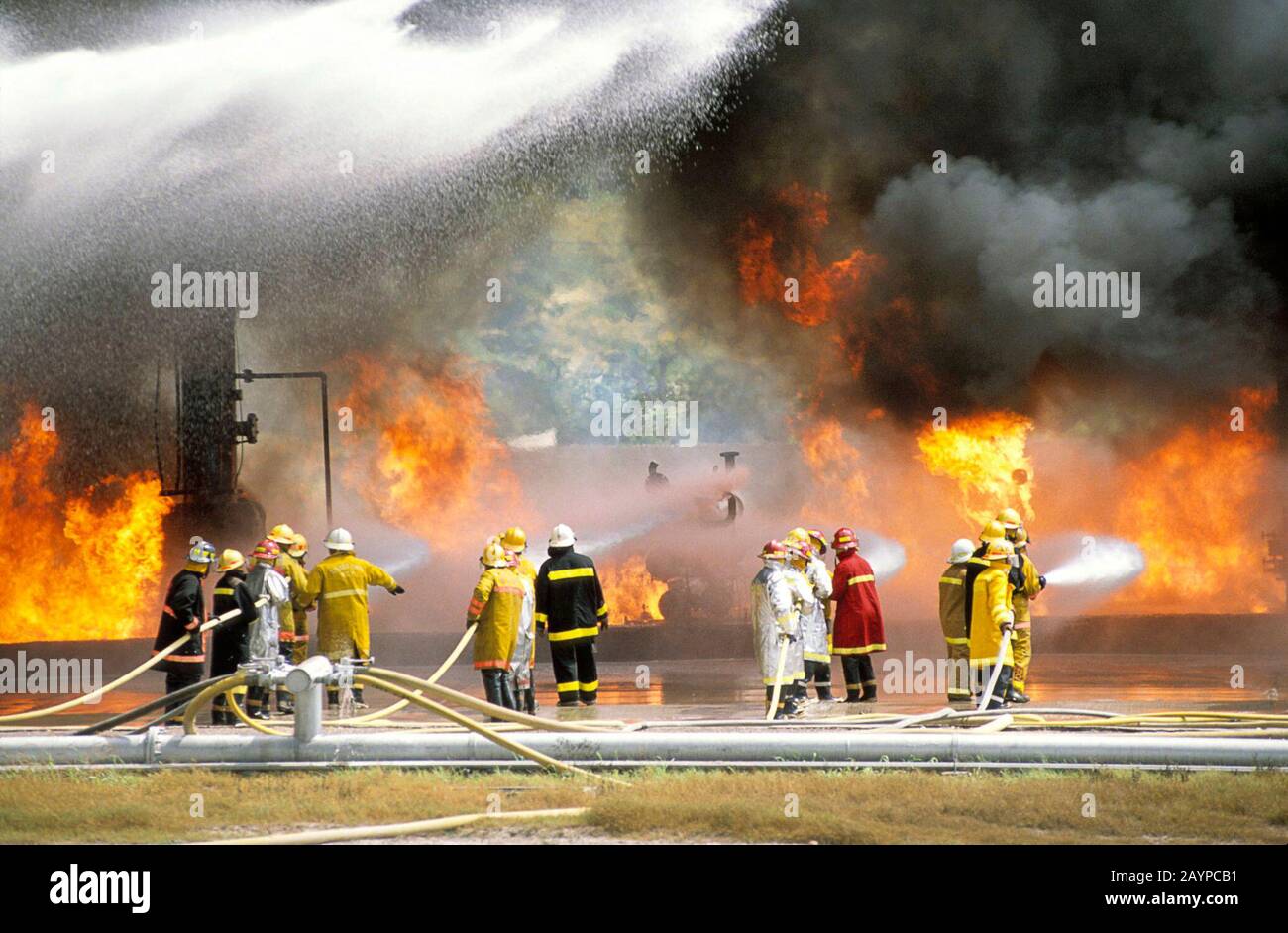 College Station, Texas USA: Industrial firefighters control chemical fire at Texas A&M training school. ©Bob Daemmrich Stock Photo