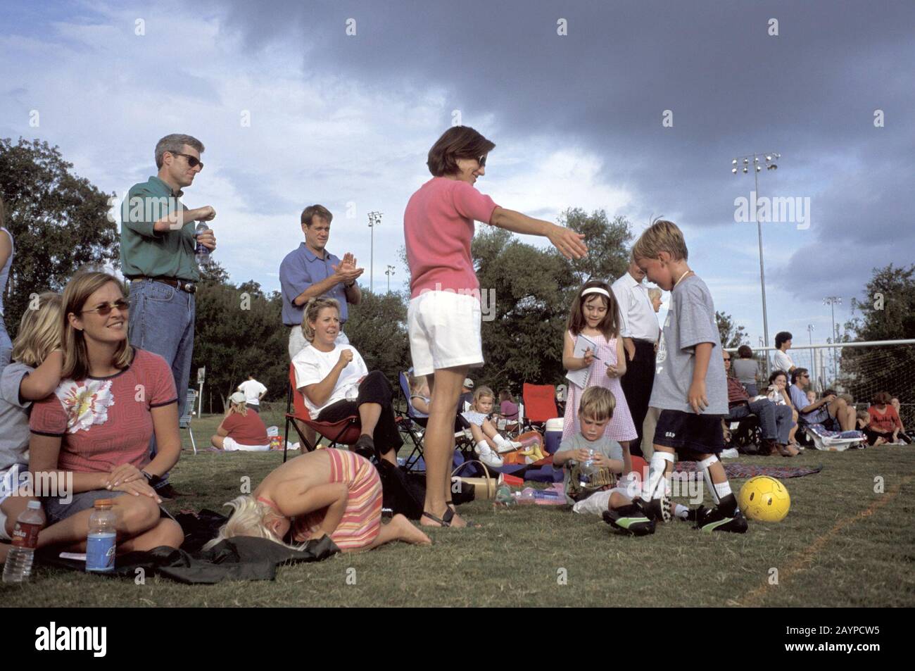 Austin, Texas: Parents and siblings watch from the sidelines during youth soccer league action for five- and six-year-old boys and girls. ©Bob Daemmrich Stock Photo