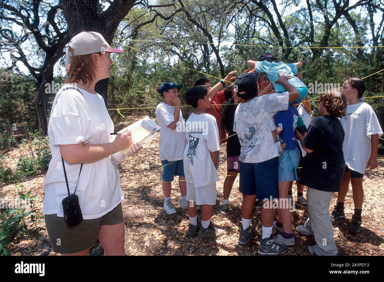 Texas: Education specialist takes notes on children's behavior at summer camp for fifth-grader students. ©Bob Daemmrich Stock Photo
