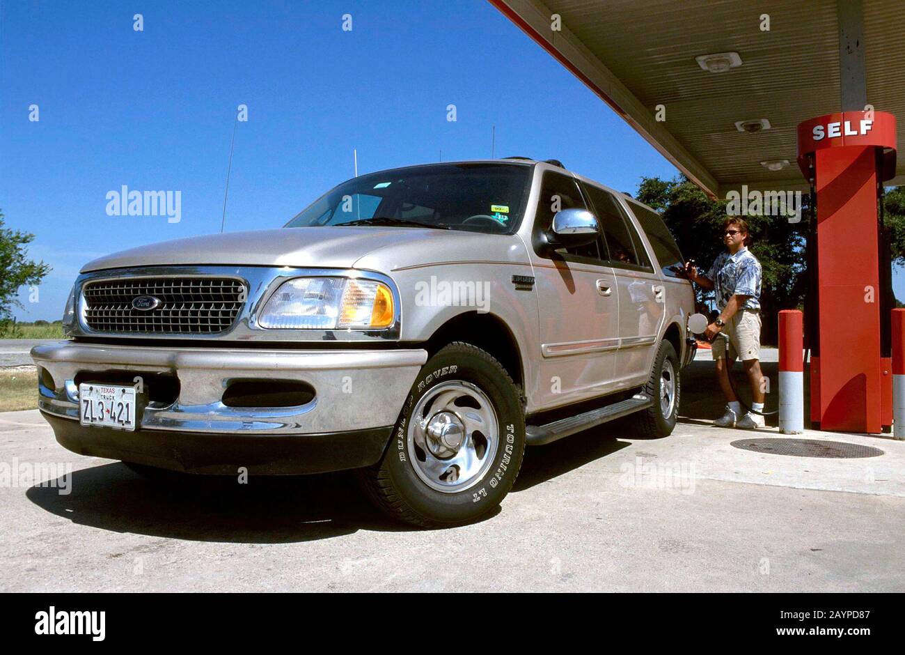 Austin, Texas: Man pumps gas into his Ford Expedition sport utility vehicle. Ford recently admitted that this model causes air pollution and is dangerous to other cars in collisions, but will continue to manufacture and sell the vehicle. ©Bob Daemmrich Stock Photo