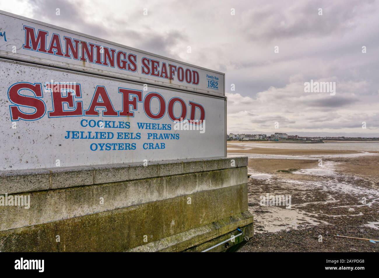 Mannings Seafood sign on a seafront fish stall at Margate at low tide. Stock Photo