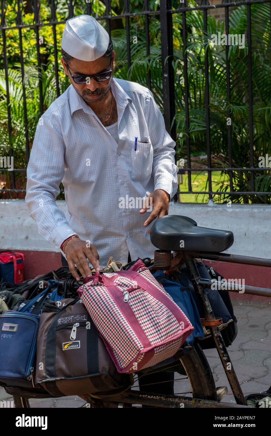 India, Mumbai aka Bombay. Dabbawalas (aka dabbawallas or dabbawallahs, tiffin wallahs) deliver lunches all over the city every day. Stock Photo