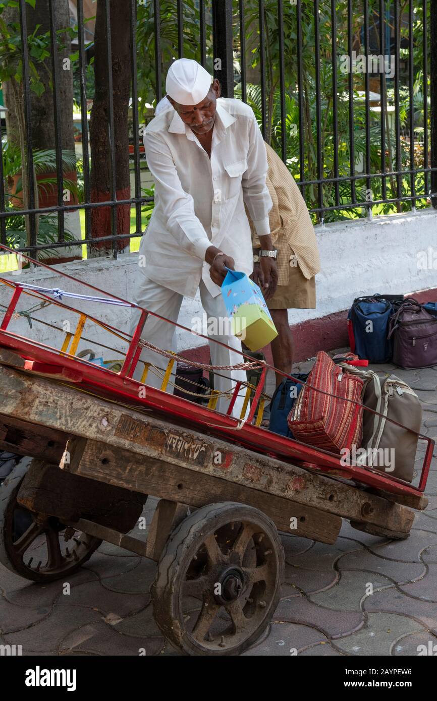 India, Mumbai aka Bombay. Dabbawalas (aka dabbawallas or dabbawallahs, tiffin wallahs) deliver lunches all over the city every day. Stock Photo