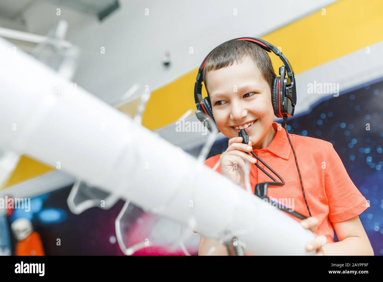Boy child using headphones and mic at the interactive space or science ...